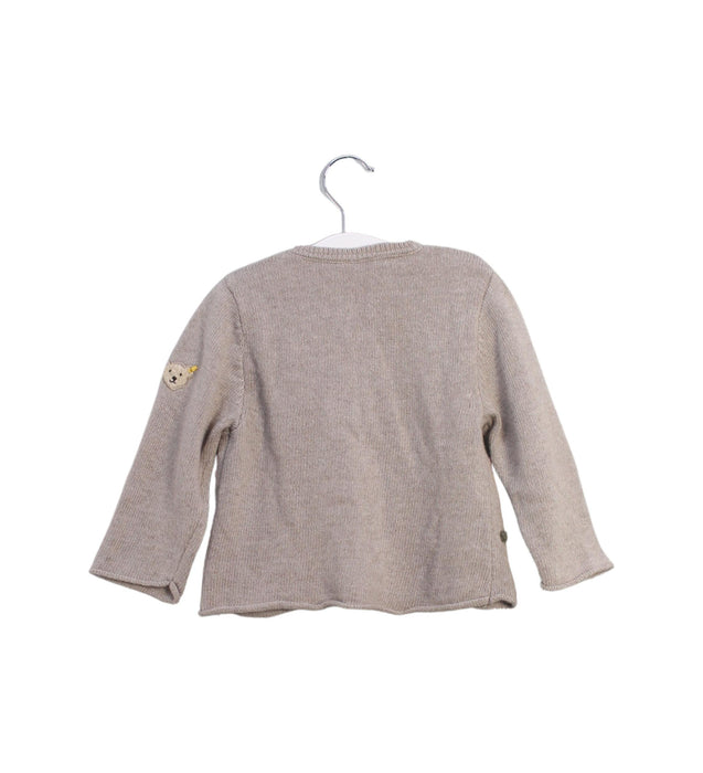 A Taupe Cardigans from Steiff in size 6-12M for girl. (Back View)