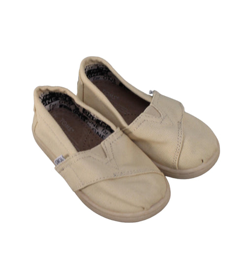 A Beige Slip Ons from Toms in size 18-24M for neutral. (Front View)