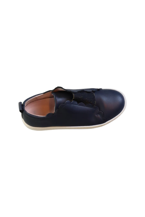 A Navy Slip Ons from Jacadi in size 9Y for girl. (Front View)