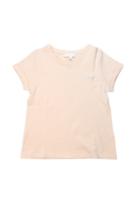 A Peach Short Sleeve T Shirts from Chloe in size 6T for girl. (Front View)