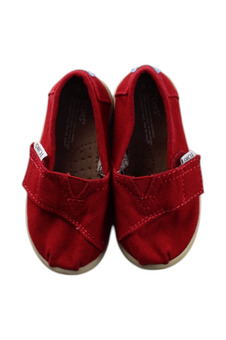 A Red Slip Ons from Toms in size 18-24M for neutral. (Back View)