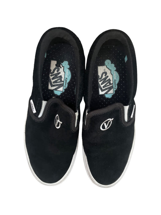 A Black Slip Ons from Vans in size 11Y for neutral. (Back View)
