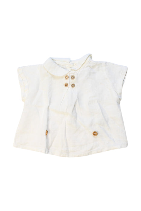 A White Short Sleeve Polos from Nanos in size 3-6M for neutral. (Front View)