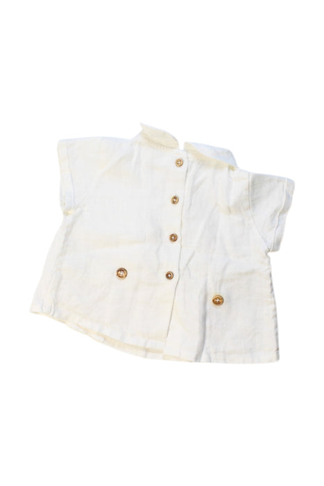 A White Short Sleeve Polos from Nanos in size 3-6M for neutral. (Back View)