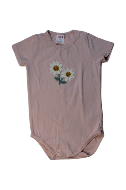A Peach Short Sleeve Bodysuits from Seed in size 6-12M for girl. (Front View)