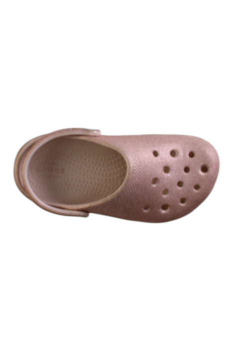 A Pink Slip Ons from Crocs in size 5T for girl. (Front View)