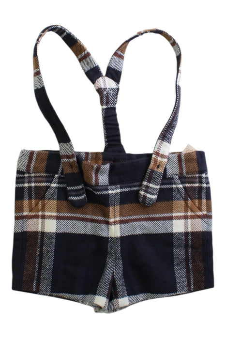 A Navy Overall Shorts from Nanos in size 6-12M for girl. (Front View)