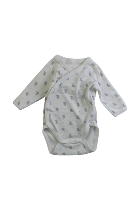 A White Long Sleeve Bodysuits from Petit Bateau in size Newborn for neutral. (Front View)