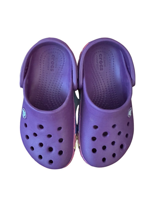 A Purple Slip Ons from Crocs in size 4T for girl. (Front View)