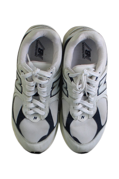 A White Sneakers from New Balance in size 13Y for boy. (Back View)