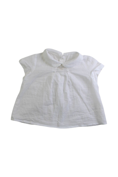 A White Sleeveless Tops from Nanos in size 3-6M for girl. (Front View)