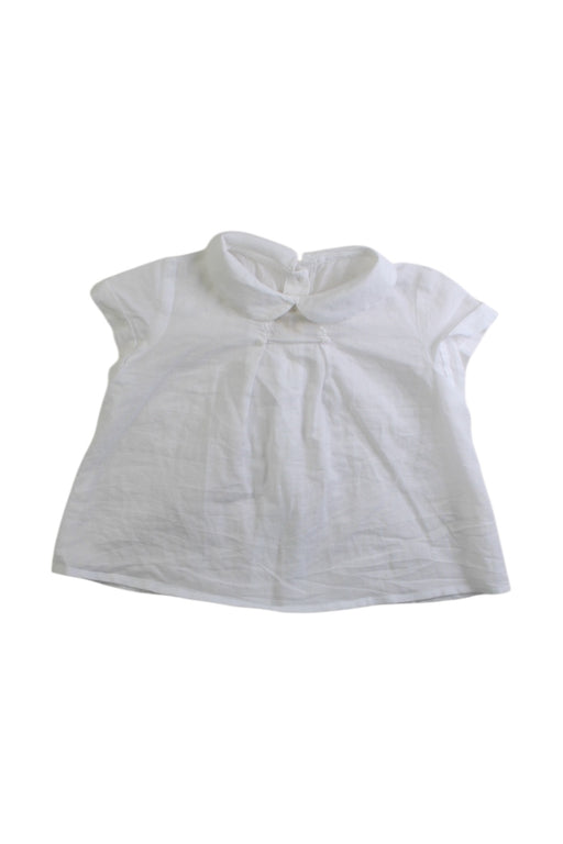 A White Sleeveless Tops from Nanos in size 3-6M for girl. (Front View)