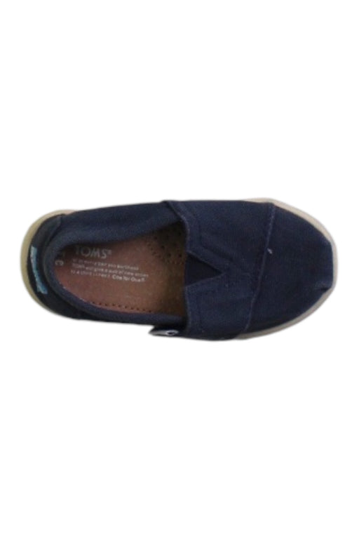 A Navy Slip Ons from Toms in size 18-24M for boy. (Front View)