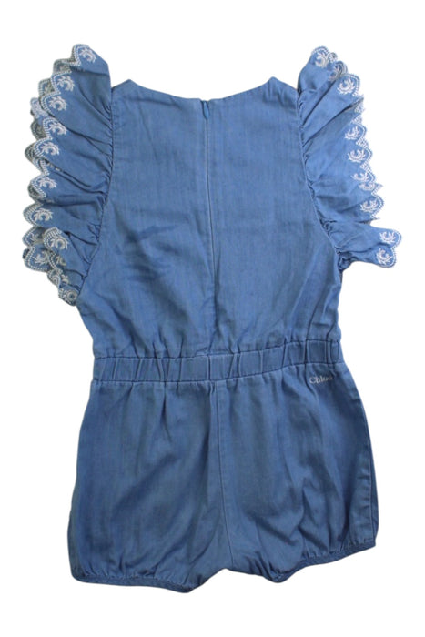 A Blue Sleeveless Rompers from Chloe in size 12-18M for girl. (Back View)