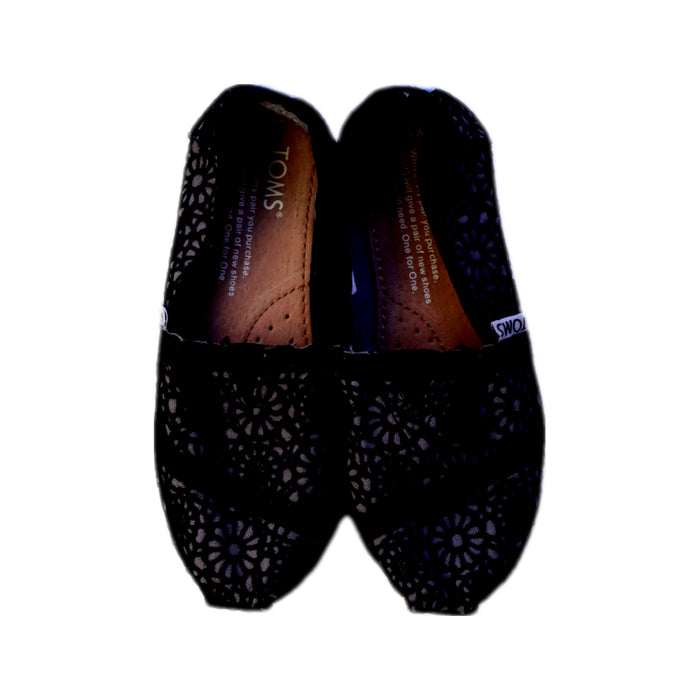A Black Slip Ons from Toms in size 6T for girl. (Back View)