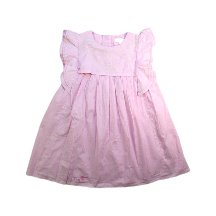 A Pink Sleeveless Dresses from Chloe in size 5T for girl. (Front View)