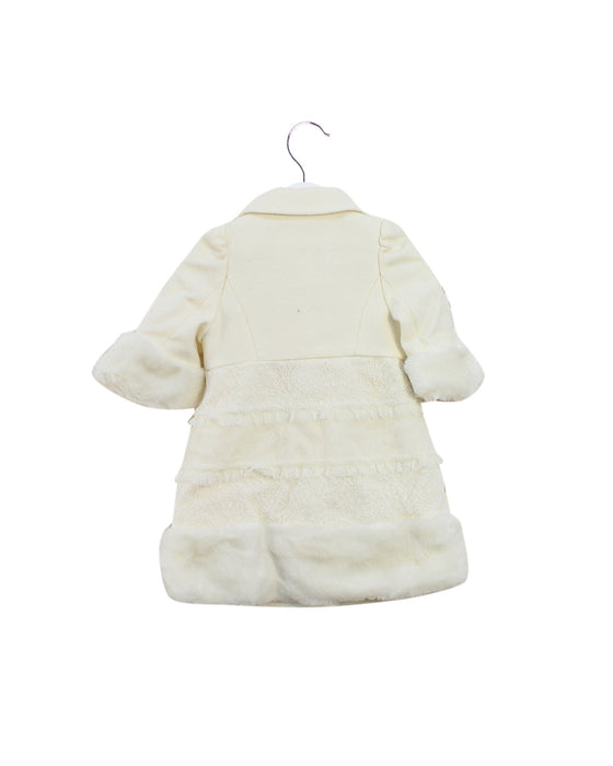 A Ivory Coats from Nicholas & Bears in size 6-12M for girl. (Back View)