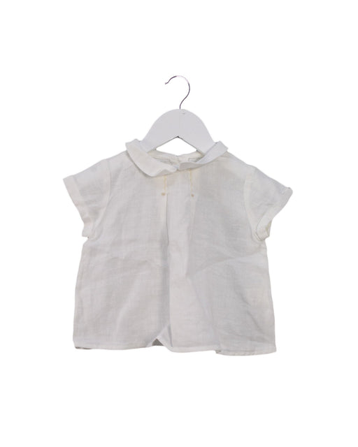 A White Short Sleeve Tops from Nanos in size 6-12M for girl. (Front View)