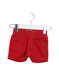 A Red Shorts from Levi's in size 3-6M for girl. (Front View)