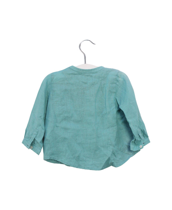 A Teal Shirts from Nanos in size 6-12M for boy. (Back View)