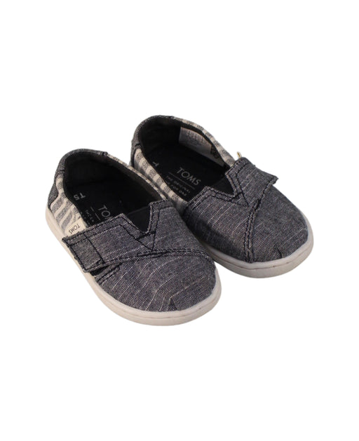 A Grey Slip Ons from Toms in size 12-18M for girl. (Front View)