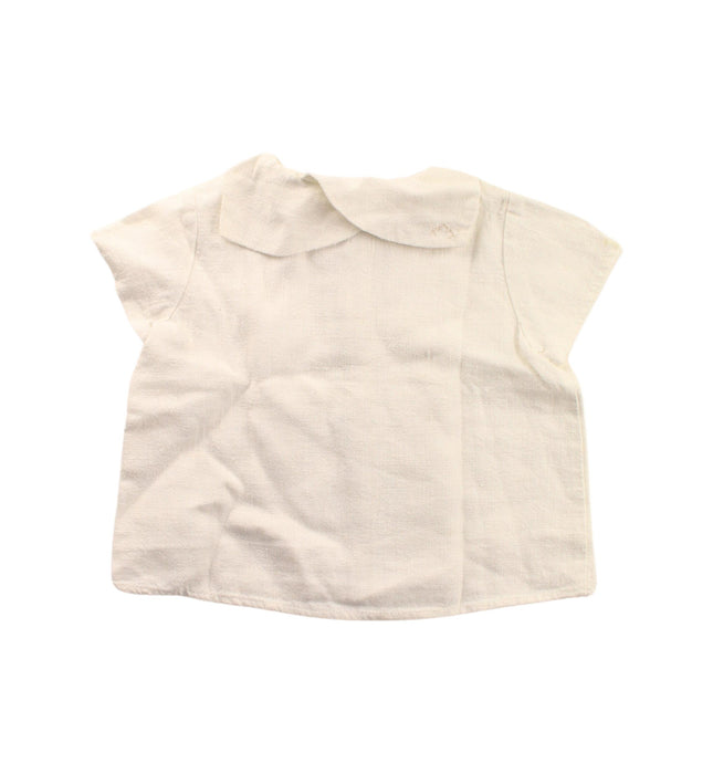 A White Short Sleeve Shirts from Nanos in size 12-18M for girl. (Back View)