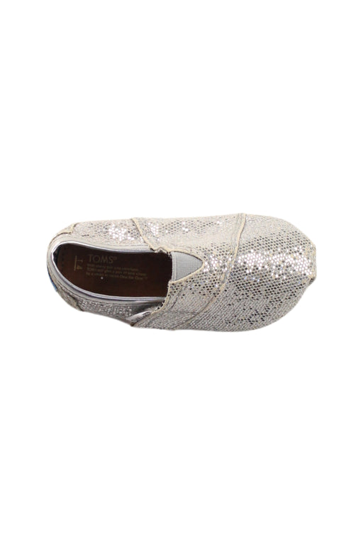 A Silver Slip Ons from Toms in size 12-18M for girl. (Front View)